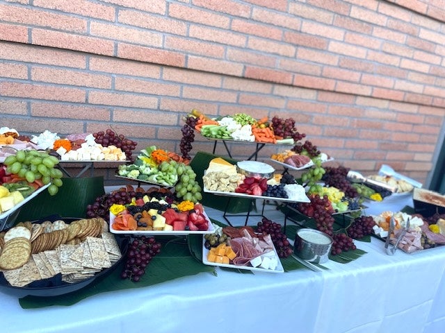 A tiered contemporary grazing table featuring artisanal charcuterie, cheeses, and fresh fruits.