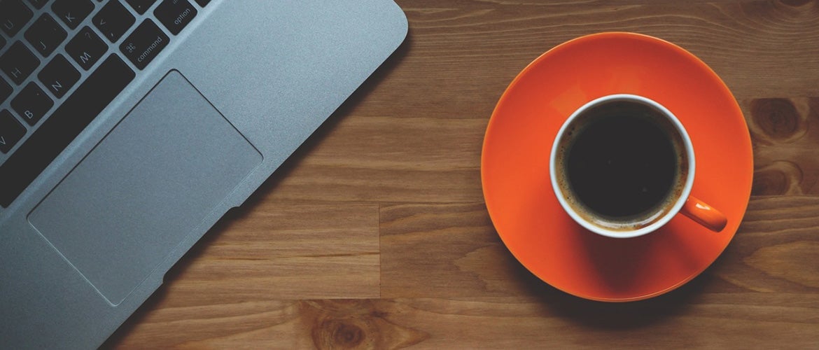 Sustainability table with coffee mug laptop