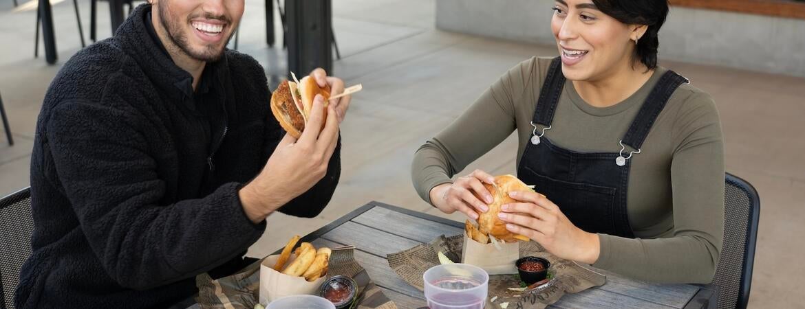 Two people eat outside at the Barn.