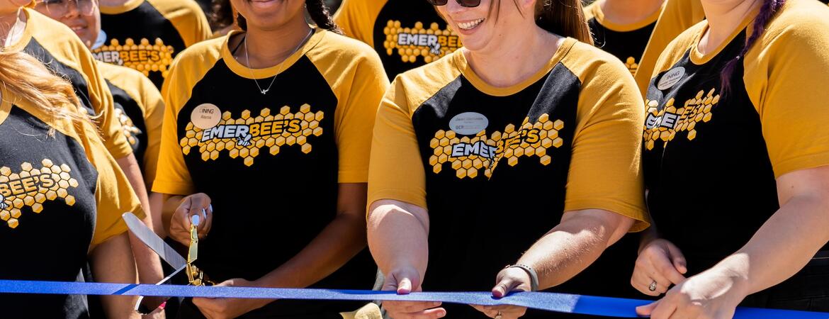 Dining Services members cut a blue ribbon at the grand opening of Emerbee's Cafe.