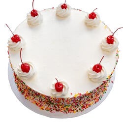 white birthday cake with cherries on top