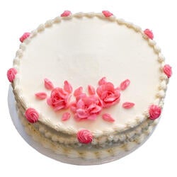 white cake with pink flowers