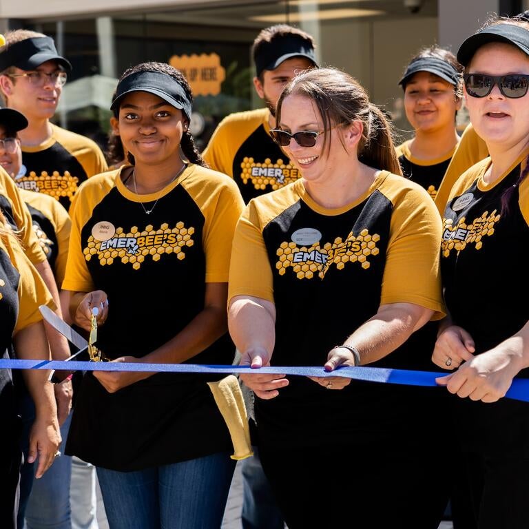 Dining Services members cut a blue ribbon at the grand opening of Emerbee's Cafe.