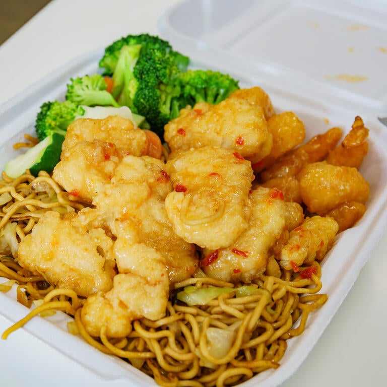 A to-go container from Panda Express, featuring chicken, chow mein and broccoli. 
