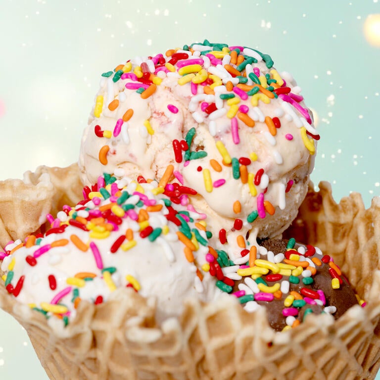 three scoops ice cream in cone with sprinkles