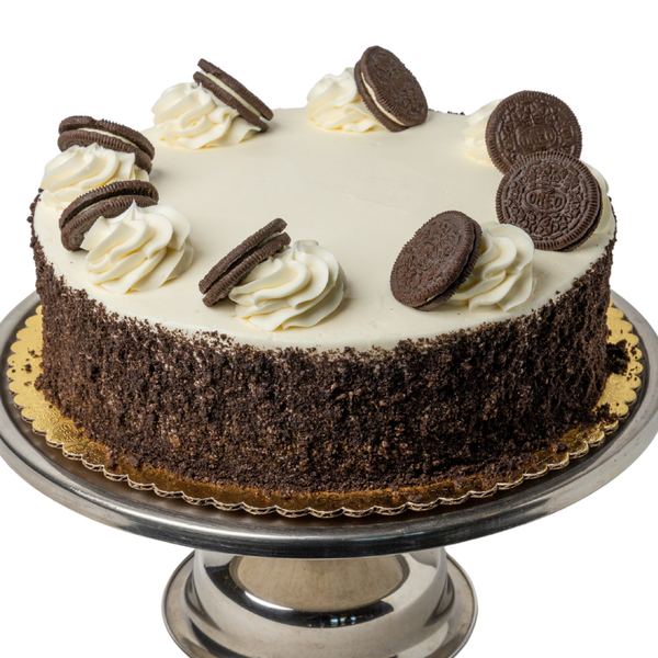 white cake with oreo crumbs on the side and oreos on top