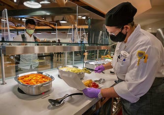 Dining Staff Serving Meal to Student