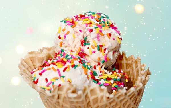three scoops ice cream in cone with sprinkles