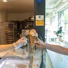 A customer receives an ice cream cone at Scoops in the HUB.