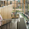 Student walking down the stairs in the Glasgow atrium.