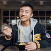 A student smiles while eating Pho from Lothian.