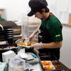 A student worker serves meals.