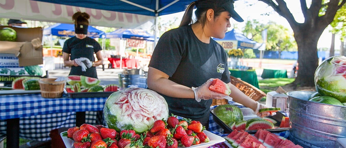 Student Serving Fruit at UCR Dining Event